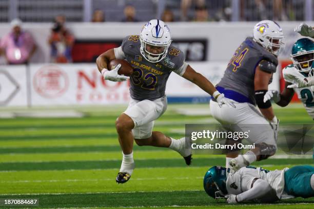 Kairee Robinson of the San Jose State Spartans runs the ball during the first half of the Hawaii Bowl against the Coastal Carolina Chanticleers at...