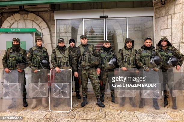 Palestinian policemen deploy outside a bank branch in the Manger Square in the biblical city of Bethlehem in the occupied West Bank on December 24...