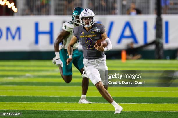 Chevan Cordeiro of the San Jose State Spartans runs the ball as Darren Lloyd of the Coastal Carolina Chanticleers gives chase during the first half...