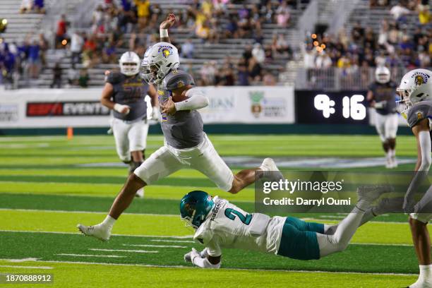 Chevan Cordeiro of the San Jose State Spartans leaps over Courtney Eubanks of the Coastal Carolina Chanticleers during the first half of the Hawaii...