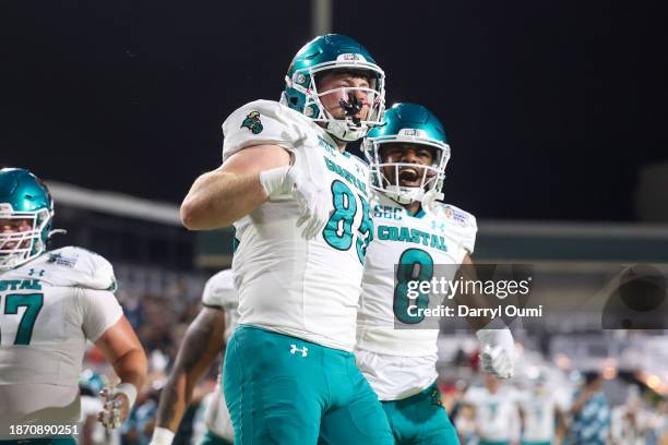 Kendall Karr and Tyson Mobley of the Coastal Carolina Chanticleers celebrate together after scoring a touchdown during the first half of the Hawaii...