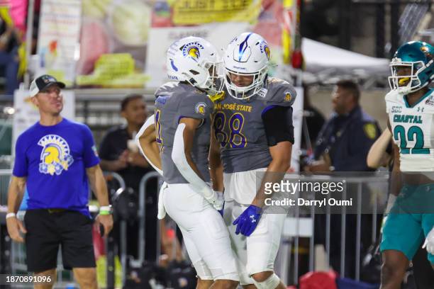 Sam Olson of the San Jose State Spartans is congratulated by Charles Ross after scoring a touchdown during the first half of the Hawaii Bow against...