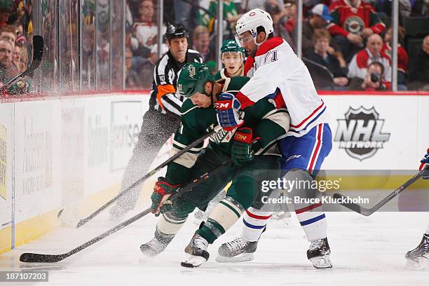 Louis Leblanc of the Montreal Canadiens defends Kyle Brodziak of the Minnesota Wild during the game on November 1, 2013 at the Xcel Energy Center in...