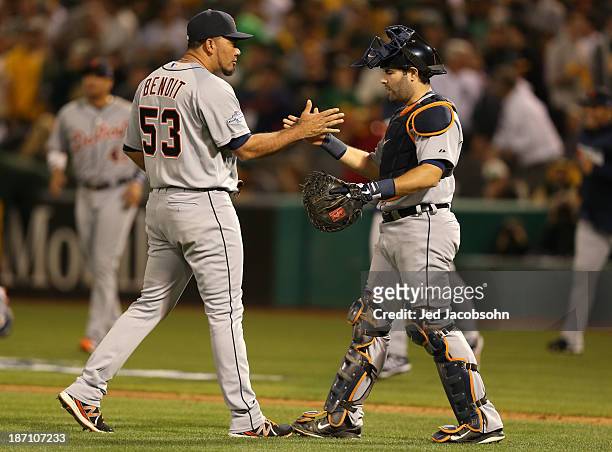 Joaquin Benoit of the Detroit Tigers celebrates with catcher Alex Avila during Game One of the American League Division Series against the Oakland...
