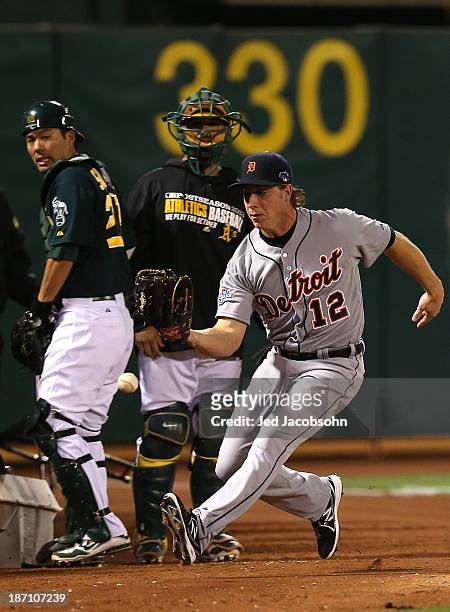 Andy Dirks of the Detroit Tigers misses a foul ball during Game One of the American League Division Series against of the Oakland Athletics on...