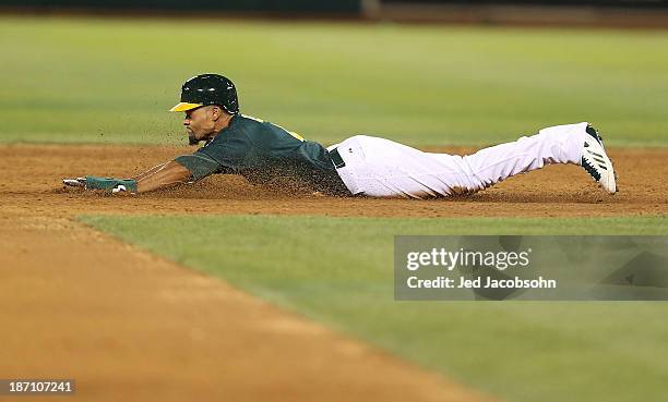 Coco Crisp of the Oakland Athletics slides into second during Game One of the American League Division Series against the Detroit Tigers on Friday,...