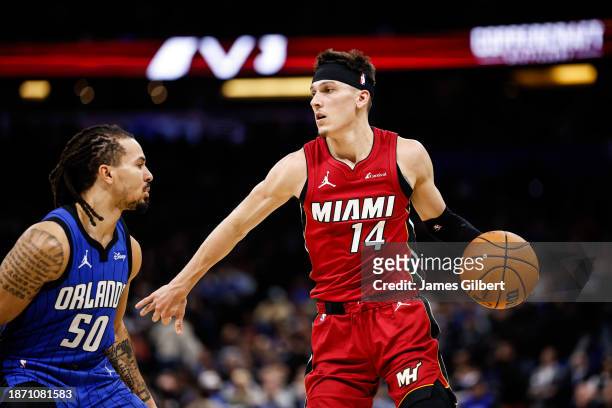 Tyler Herro of the Miami Heat dribbles the ball during the first half of a game against the Orlando Magic at Amway Center on December 20, 2023 in...