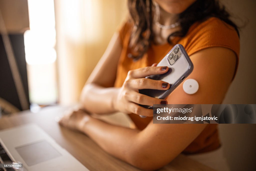 Young diabetic patient monitoring glucose level