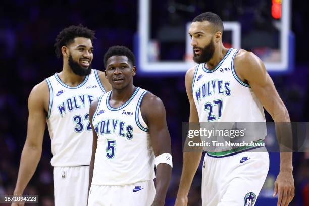 Anthony Edwards of the Minnesota Timberwolves looks on between teammates Karl-Anthony Towns and Rudy Gobert during the second quarter against the...