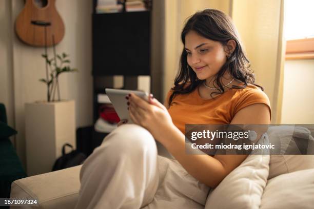 young woman using digital tablet - continuous glucose monitor stock pictures, royalty-free photos & images