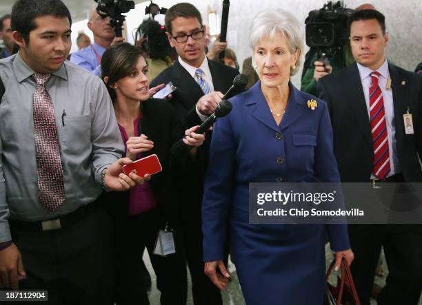 Health and Human Services Secretary Kathleen Sebelius is pursued by reporters after testifying before the Senate Finance Committee about the...