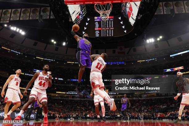 LeBron James of the Los Angeles Lakers goes up for a dunk against the Chicago Bulls during the first half at the United Center on December 20, 2023...