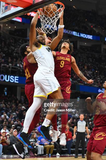 Talen Horton-Tucker of the Utah Jazz dunks over Jarrett Allen and Craig Porter of the Cleveland Cavaliers during the third quarter at Rocket Mortgage...