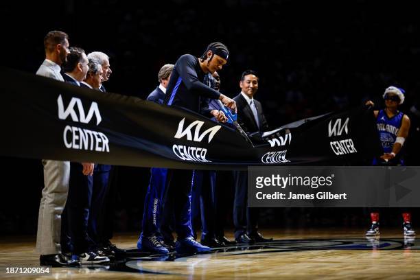 Paolo Banchero of the Orlando Magic cuts a ribbon to celebrate the first game at the Kia Center held between the Orlando Magic and the Miami Heat on...