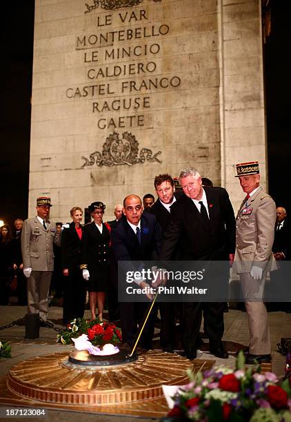 Wyatt Crockett of the New Zealand All Blacks and NZRU CEO Steve Tew rekindle the flame at the Tomb of the Unknown Soldier at the Arc de Triomphe on...