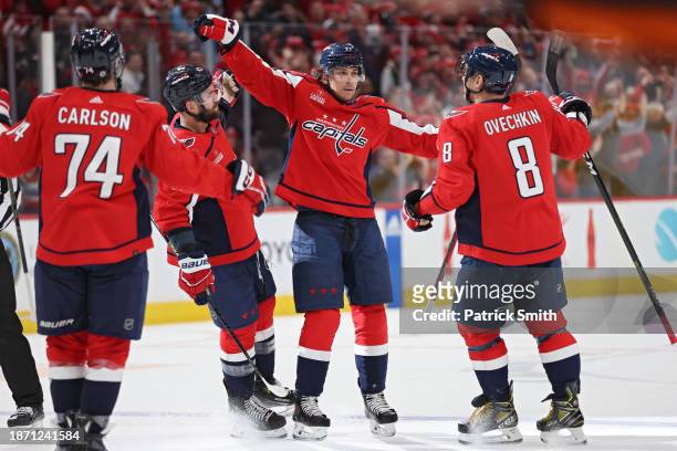 Dylan Strome of the Washington Capitals celebrates with teammates after scoring the game-winning goal against the New York Islanders during overtime...
