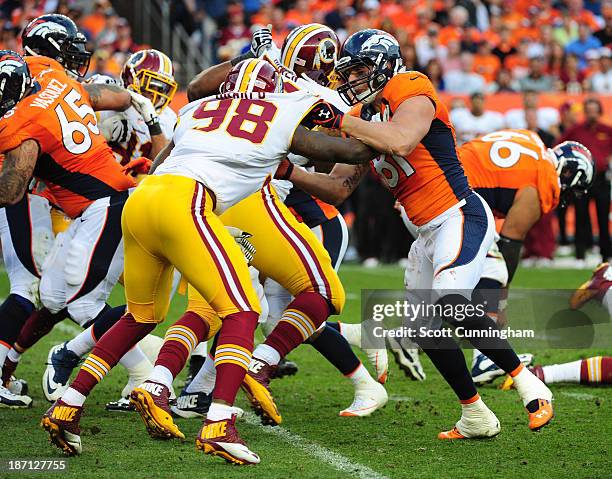 Joel Dreessen of the Denver Broncos blocks against Brian Orakpo of the Washington Redskins at Sports Authority Field on October 27, 2013 in Denver,...