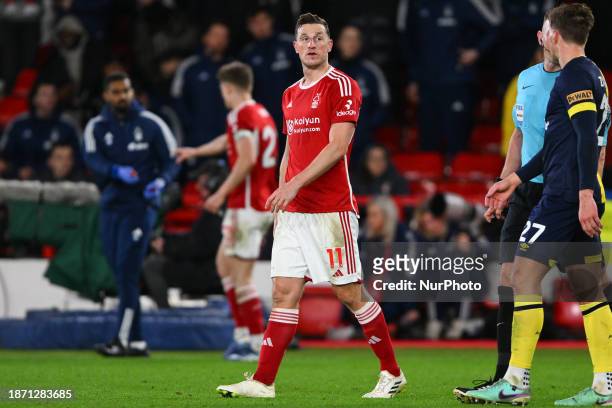 Chris Wood of Nottingham Forest is glancing up at the LCD screen to watch a replay of his equalizing goal during the Premier League match between...