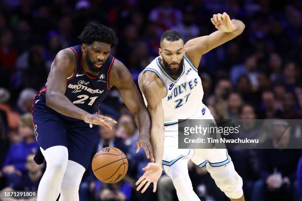 Joel Embiid of the Philadelphia 76ers and Rudy Gobert of the Minnesota Timberwolves challenge for the ball during the third quarter at the Wells...