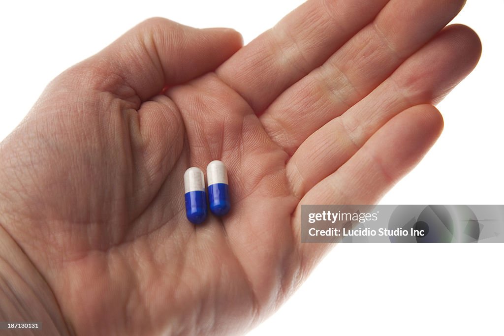 Hand holding pills