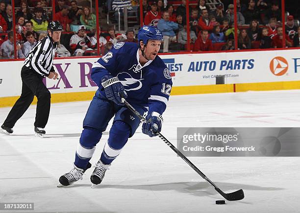 Ryan Malone of the Tampa Bay Lightning skates with the puck during their NHL game against the Carolina Hurricanes at PNC Arena on November1, 2013 in...