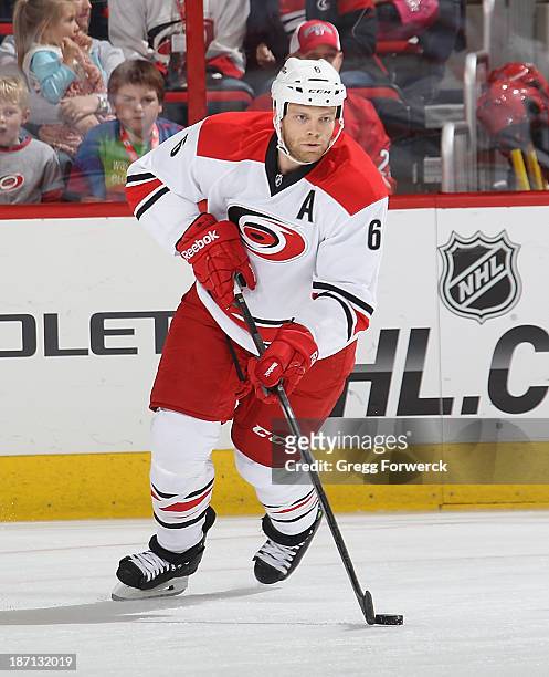 Tim Gleason of the Carolina Hurricanes carries the puck during their NHL game against the Tampa Bay Lightning at PNC Arena on November1, 2013 in...