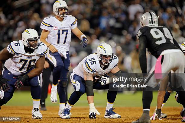 Quarterback Philip Rivers of the San Diego Chargers calls out the snap count while guard Jeromey Clary and tackle D.J. Fluker prepare to block...