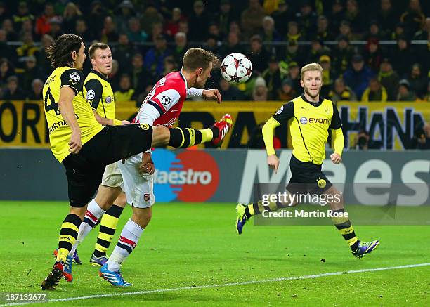 Neven Subotic of Borussia Dortmund fails to stop Aaron Ramsey of Arsenal score the first goal during the UEFA Champions League Group F match between...