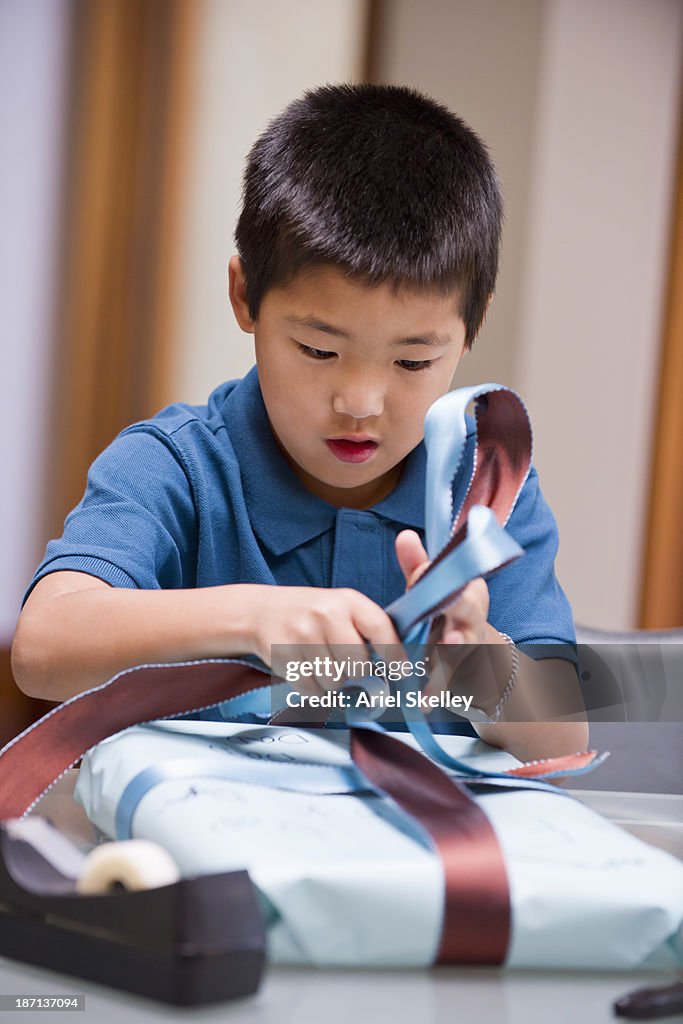 Japanese boy wrapping birthday present