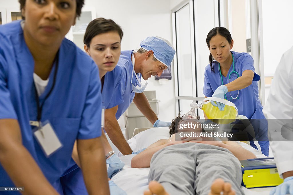 Doctors working on patient in the emergency room