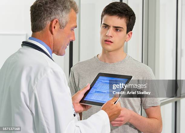 doctor using digital tablet with patient - medical document stock pictures, royalty-free photos & images