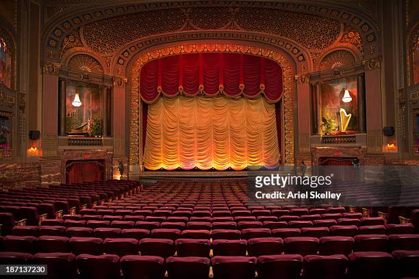 empty seats in ornate movie theater - theater stock-fotos und bilder