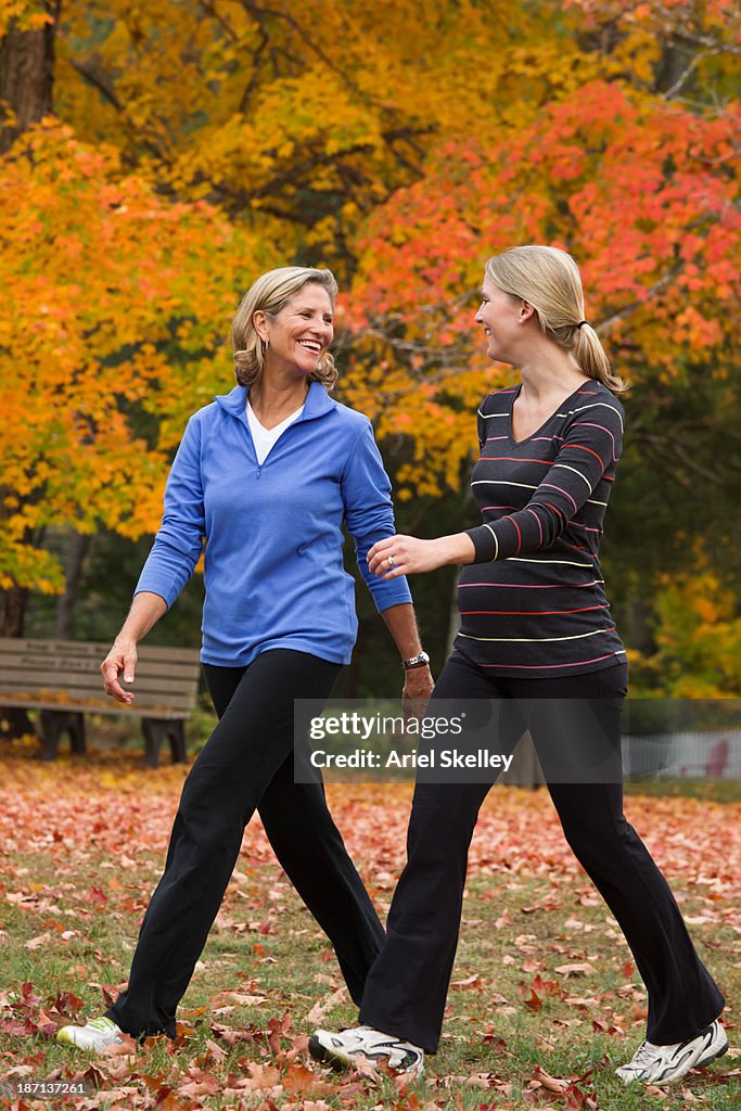 Caucasian mother and daughter walking in park