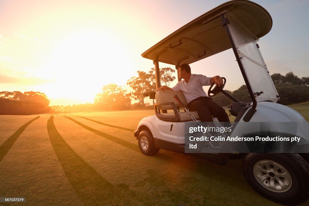 Caucasian man driving on golf course