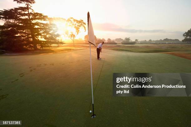 caucasian man putting on golf course - golf australia stock-fotos und bilder