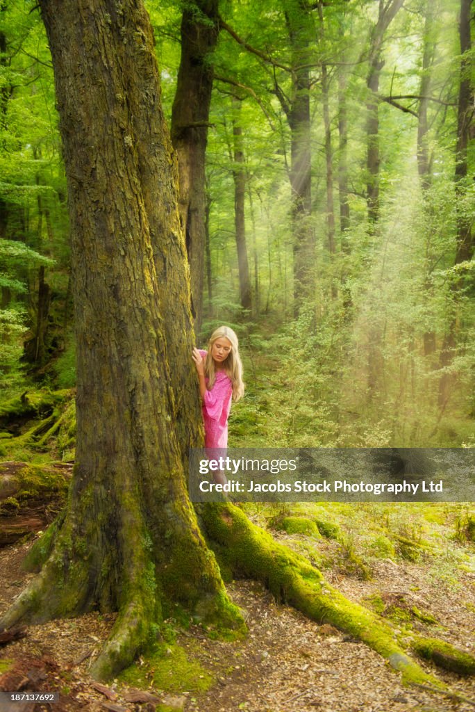 Caucasian woman playing in forest