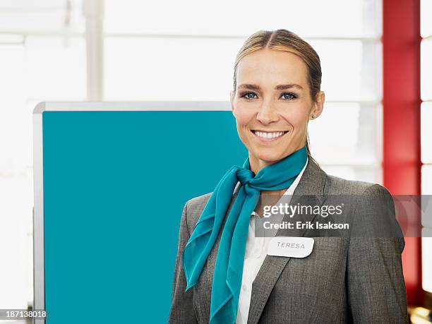 caucasian hostess smiling - namensschild stock-fotos und bilder