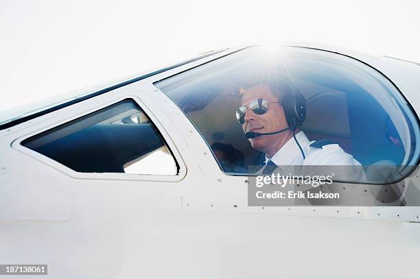 caucasian pilot in airplane cockpit - captains day stock-fotos und bilder