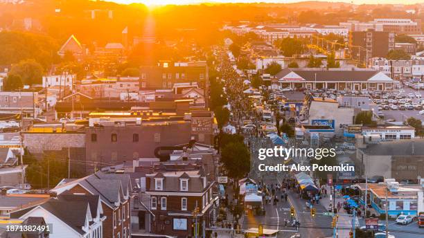 festival de otoño de penn avenue en una pequeña ciudad al atardecer. camiones de comida concurridos y carpas de entretenimiento en la fiesta callejera. vista aérea - reading pennsylvania fotografías e imágenes de stock