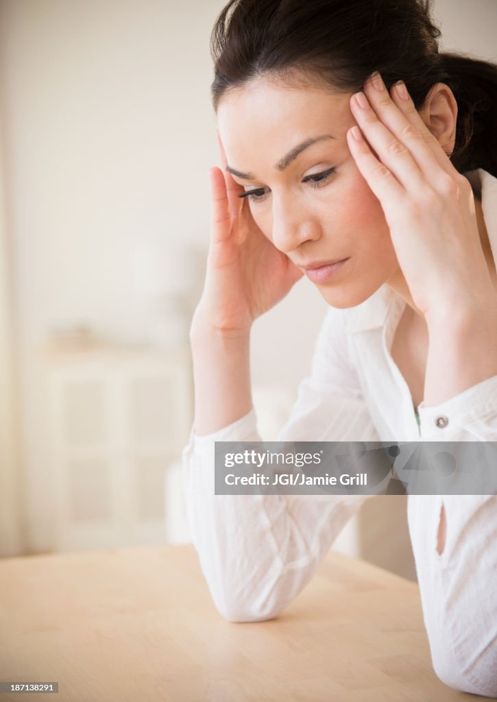 Caucasian woman rubbing her temples