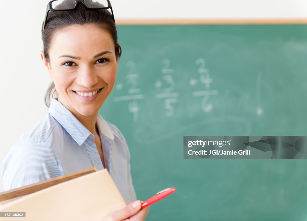 Caucasian teacher smiling in classroom