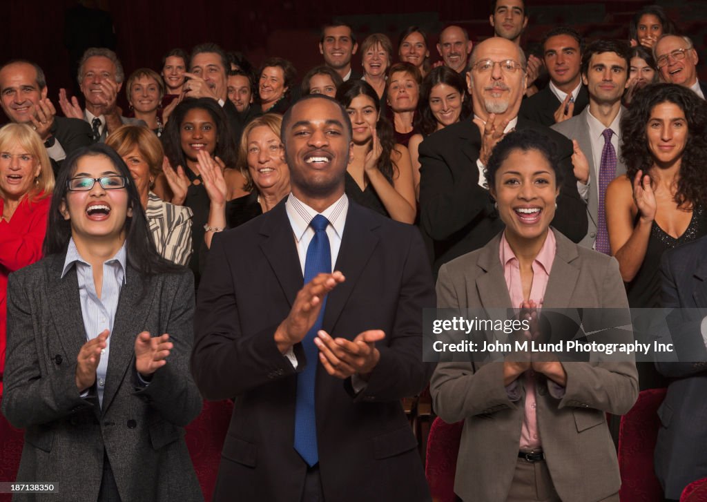 Businesspeople clapping in audience