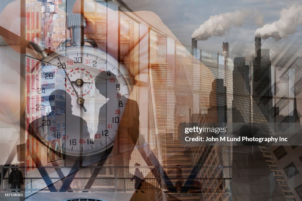 Silhouette of business people and skyscrapers over stopwatch