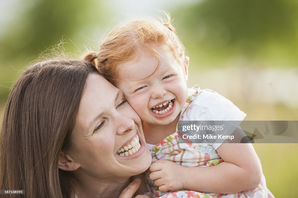 Caucasian mother and daughter playing outdoors