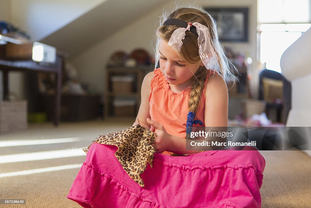 Caucasian girl cutting fabric