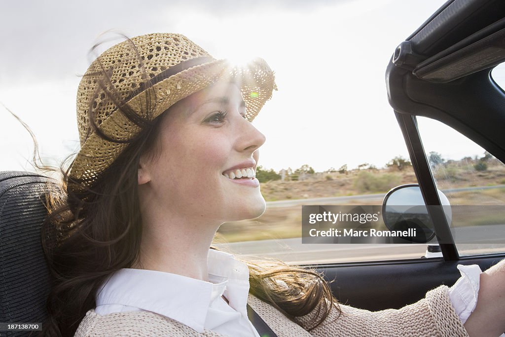 Caucasian woman driving convertible