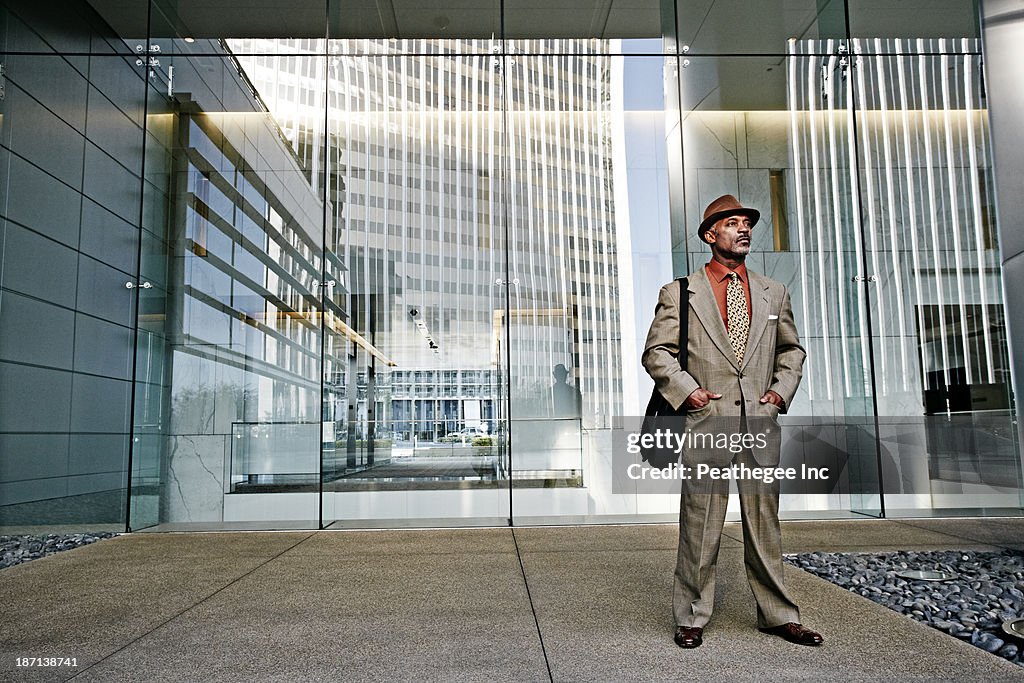 Black businessman standing outside office