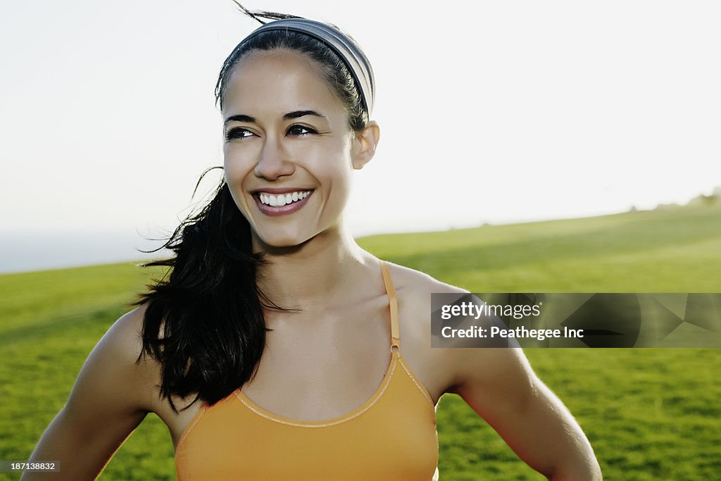 Hispanic woman smiling in field