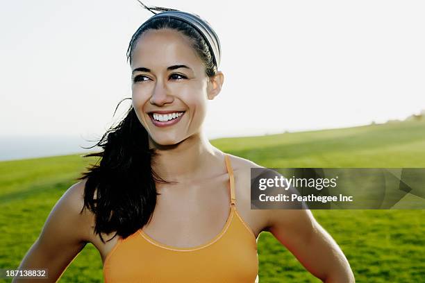 hispanic woman smiling in field - open workouts bildbanksfoton och bilder