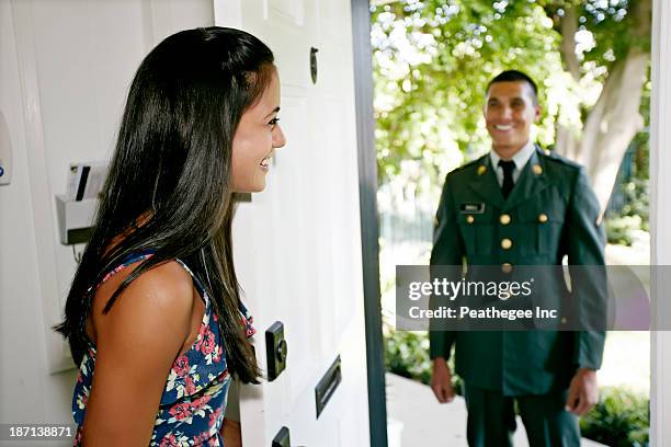 woman greeting soldier boyfriend at door - man opening door woman bildbanksfoton och bilder